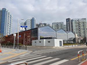 an empty city street with a large glass building at 광안리 오션뷰 in Kwangan-dong