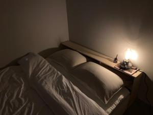 a bedroom with a bed with a light on it at 광안리 오션뷰 in Kwangan-dong