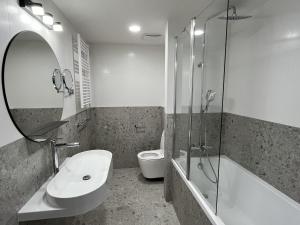 a bathroom with a sink and a shower and a toilet at Hotel ILF in Prague +45 photos