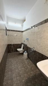 a bathroom with a toilet and a sink at Gravity Groups VHR Residency - near santho lawns in Pondicherry +68 photos