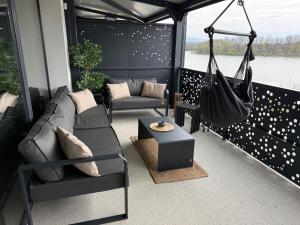 a screened in porch with a couch and a swing at Panorama Lake Residence in Horní Soběšovice