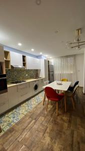 a kitchen with a table and chairs and a dining room at Casa hermosa draria in Draria