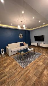 a living room with a white couch and a tv at Casa hermosa draria in Draria