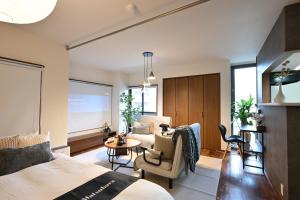 a bedroom with a bed and a living room at EN Matsubara in Kagoshima