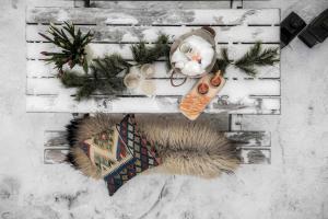 a winter scene with a table with a christmas ornament at TH622- Premium ski-in,out Chalet with 8 bedroom, jacuzzi, sauna in Hovi