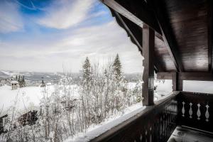 a view from the balcony of a house in the snow at TH622- Premium ski-in,out Chalet with 8 bedroom, jacuzzi, sauna in Hovi