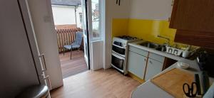 a kitchen with a sink and a stove top oven at Brookside Lodge, central Dawlish in Dawlish