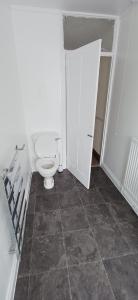 a bathroom with a white toilet in a room at Brookside Lodge, central Dawlish in Dawlish +16 photos