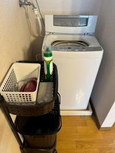 a washer and dryer sitting in a room at apartment hotel myu didymi in Utsunomiya