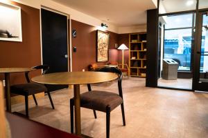 a room with two tables and chairs and a living room at Roami at The Fitz in Saint Paul