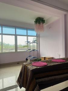 a room with a table with a plant on it at Silo namlo 2BHK in Duimukh