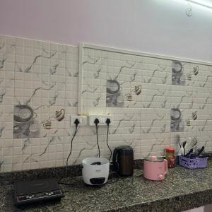 a kitchen counter with a toaster a coffee maker and a toaster at Silo namlo 2BHK in Duimukh