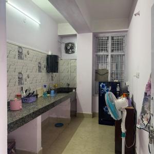 a kitchen with a counter and a sink and a refrigerator at Silo namlo 2BHK in Duimukh