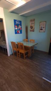 a dining room with a table and chairs at Camping "le Pécos" appartement confort 5 personnes in Grandson