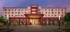 a large white building with a sign on it at Vivanta Ekta Nagar in Kevadia