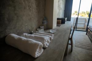 four towels on a wooden table in a room at Surf's Up LOFT in Weligama +76 photos
