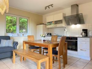 a kitchen with a wooden table and chairs in a room at Ferienhaus VogelMeer in Marlow
