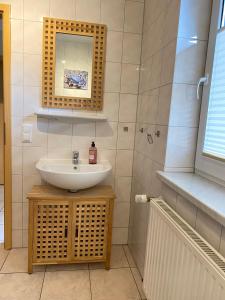 a bathroom with a sink and a mirror at Ferienhaus VogelMeer in Marlow +7 photos