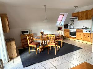 a kitchen with a table and chairs in a kitchen at Finnhaus Lisa in Marlow