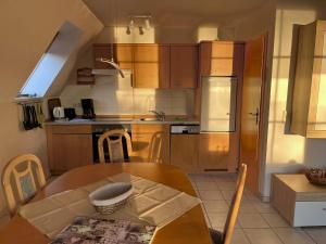 a kitchen with a wooden table and a kitchen with a sink at Finnhaus Annika in Marlow