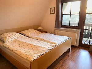 a bedroom with two beds and a window at Finnhaus Annika in Marlow