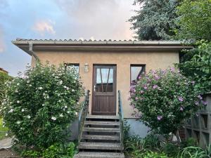 a small house with stairs leading up to a door at Ferienwohnung Graureiher in Marlow