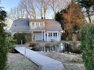 a house with a pond in front of it at Ferienvilla Recknitztal in Marlow