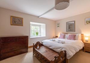 a bedroom with a large bed and a window at Swale View in Feetham