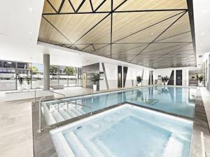 a large swimming pool in a building at Olympic Optimum Accor in Sydney