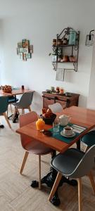 a dining room with a wooden table and chairs at Hôtel Le Relais in Fleurance