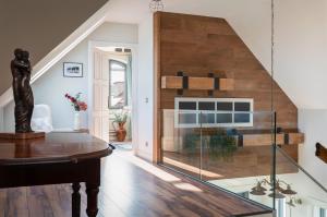 a living room with a glass staircase with a fireplace at Pannon Grace Balaton in Dörgicse