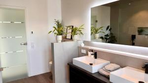 a bathroom with a white sink and a mirror at Modern Luxury Apartment in Karsau +43 photos
