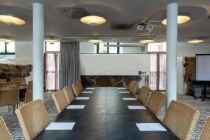 a conference room with a long table and chairs at Home Hotel Victoria in Jönköping
