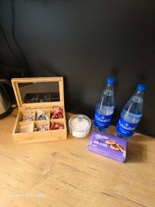two bottles of water and a box on a table at D20 apartamentai in Mažeikiai