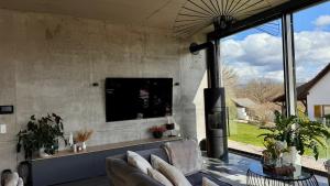 a living room with a couch and a tv at Modern Luxury Apartment in Karsau
