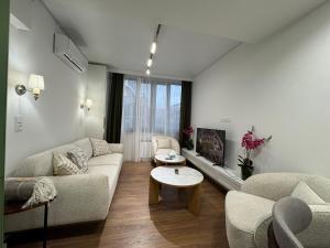 a living room with a couch and a table at Modern apartment in Yerevan +2 photos