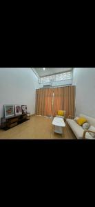 a living room with a couch and a table at Quiet place with duplex room in Ban Kohong +2 photos