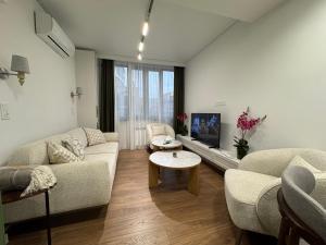 a living room with a couch and a tv at Modern apartment in Yerevan
