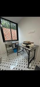 a room with a table and a window at Quiet place with duplex room in Ban Kohong