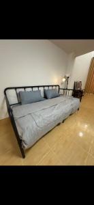 a bedroom with a large bed with blue pillows at Quiet place with duplex room in Ban Kohong