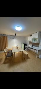 a living room with a wooden table and chairs at Quiet place with duplex room in Ban Kohong