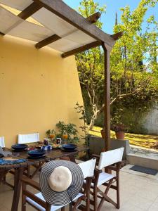 a patio with a table and chairs and an umbrella at Sunlit Village Escape in Kompítsion