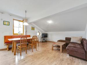 a living room with a table and a couch at Chalet in Mittersill near Ski Slopes in Mittersill