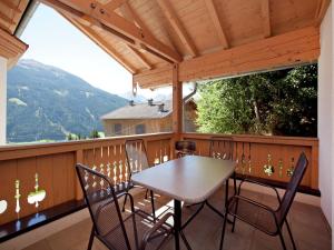 a table and chairs on a balcony with a view at Chalet in Mittersill near Ski Slopes in Mittersill