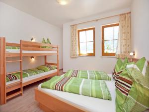 a bedroom with two bunk beds and two windows at Chalet in Mittersill near Ski Slopes in Mittersill +86 photos