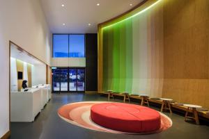 a large room with a red rug and a green wall at MU Hotel in Ipoh