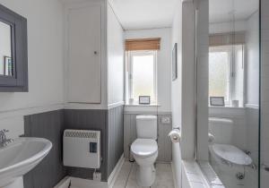 a white bathroom with a toilet and a sink at Swale View in Feetham +43 photos
