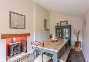 a dining room with a table and a stove at Swale View in Feetham