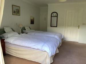 A bed or beds in a room at Riverdown B&B