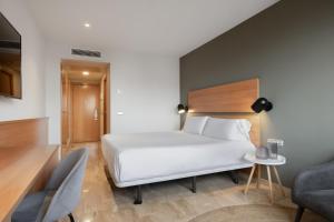 a hotel room with a bed and a chair at Hotel SB Express Tarragona in Tarragona